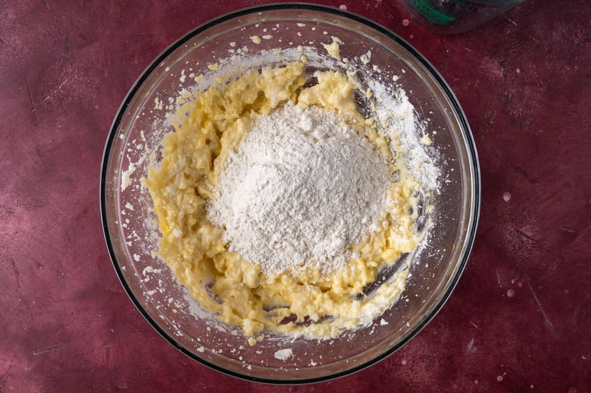 flour over wet ingredients in a bowl