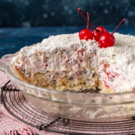 million dollar fruit pie in a pan with cherries on top