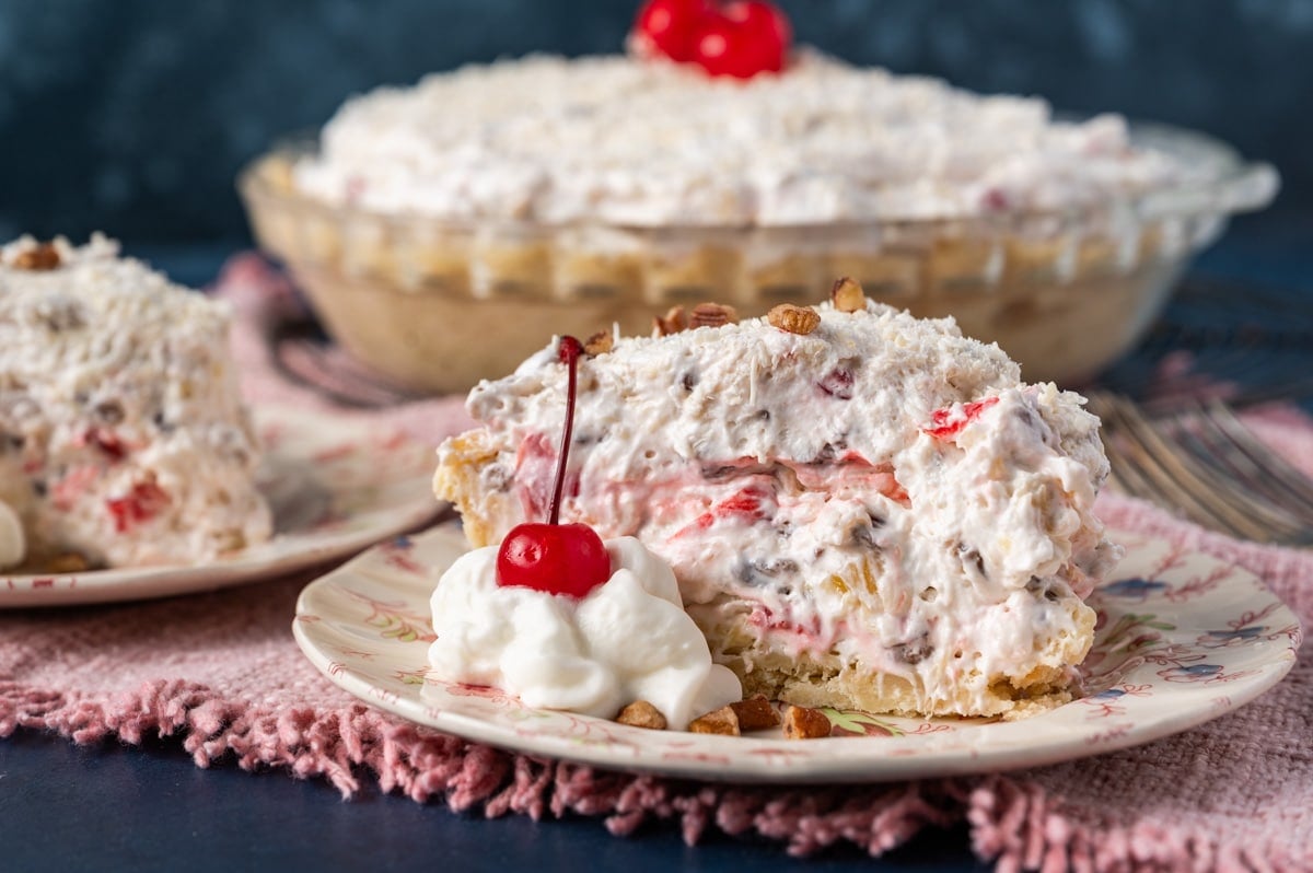 creamy fruit pie on a plate with a cherry