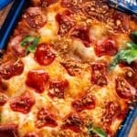 pizza pasta casserole with hot honey and toasted bread crumbs on top