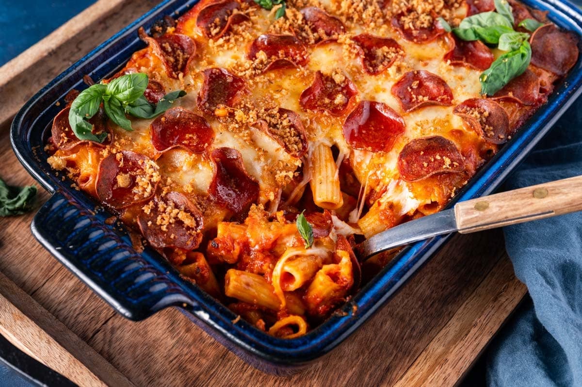 a scoop of pasta with pizza toppings in a casserole