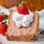 a piece of strawberry angel food cake on a plate with whipped cream