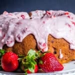 a glazed strawberry bundt cake on a table