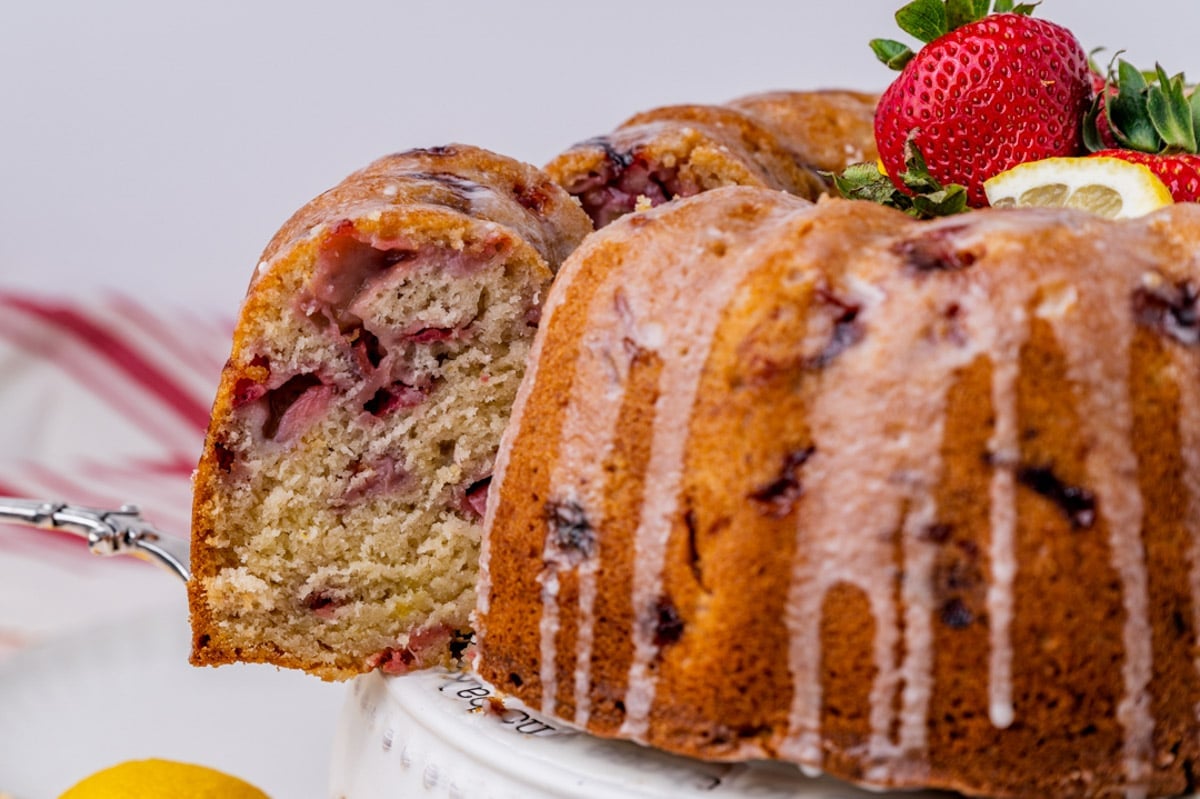 pulling out a slice of lemon strawberry cake