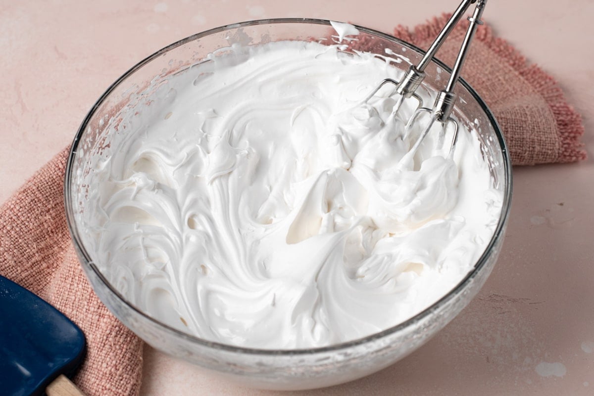 beaters in a bowl with whipped frosting