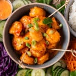 a bowl of bang bang shrimp with toothpicks