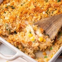 a wooden spoon in a chicken casserole with ritz crackers