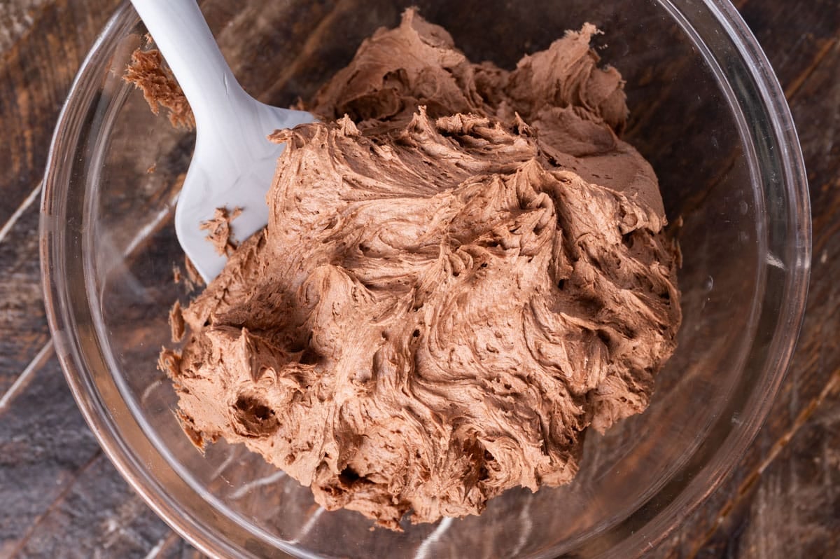chocolate frosting in a bowl with a spatula