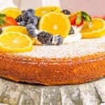 fresh fruit piled on top of a lemon olive oil cake