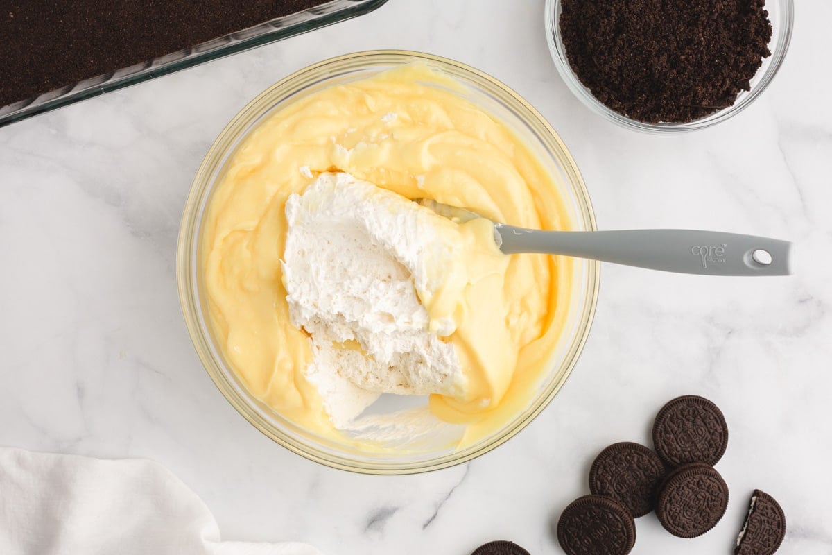 folding whipped cream and pudding together