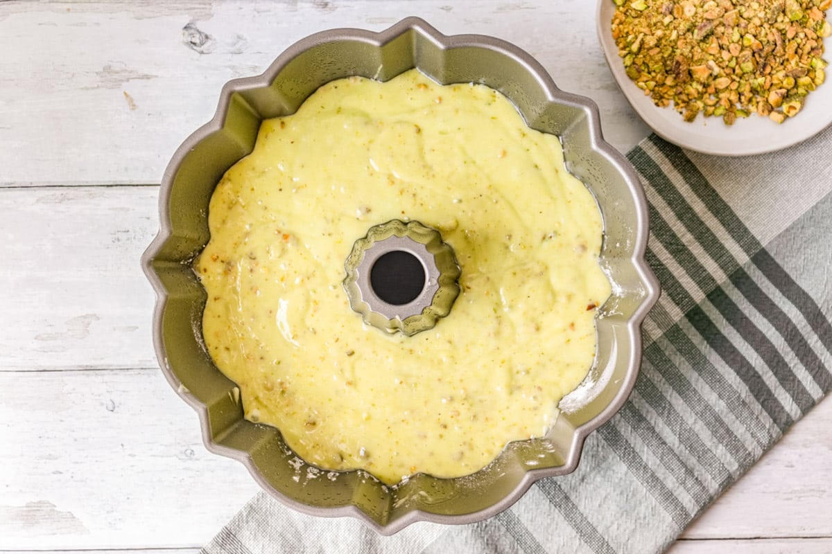 unbaked pistachio cake in a bundt pan
