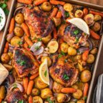 overhead view of chicken and veggies on a sheet pan