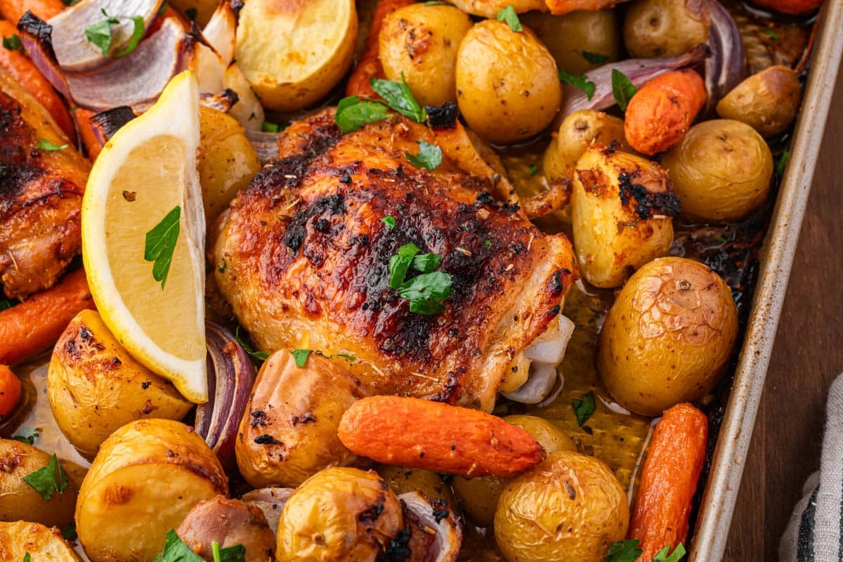closeup of overhead view of sheet pan chicken thighs with veggies