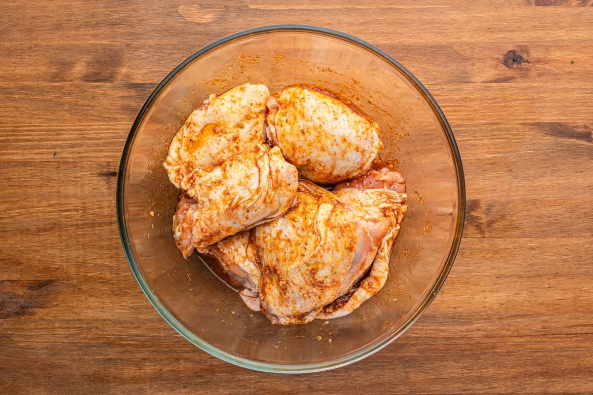 marinated chicken thighs in a glass bowl