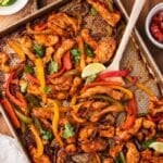 sheet pan chicken fajitas on a table with toppings