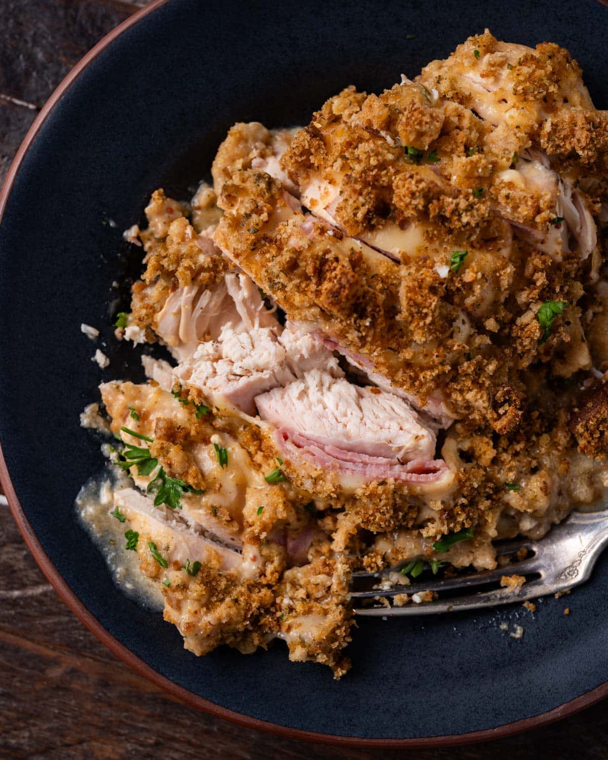 a sliced piece of chicken cordon blue on a plate