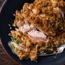 a sliced piece of chicken cordon blue on a plate