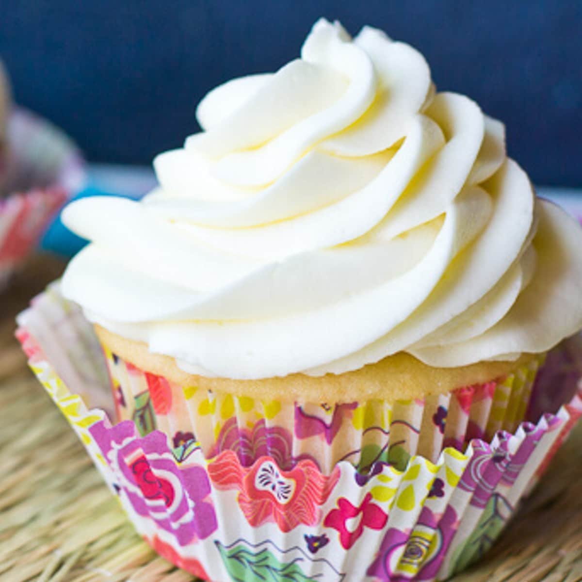 a white cupcake with a swirl of white icing