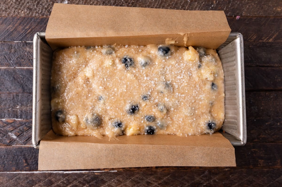 unbaked banana bread with blueberries in a pan