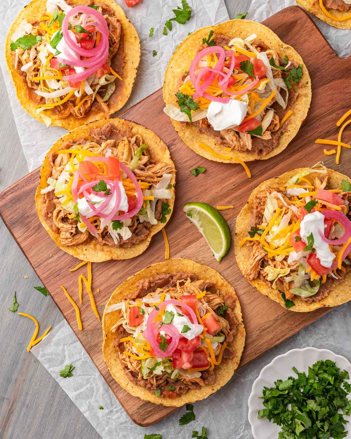 tostadas sitting on a wooden cutting board