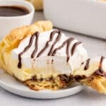 a fork with a bite out of cream puff dessert