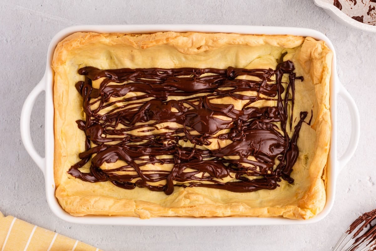 chocolate drizzled over puffy crust for cake