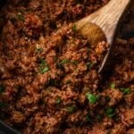 a spoon in a slow cooker with taco meat