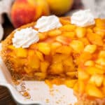 peach jello pie with whipped cream in a pan