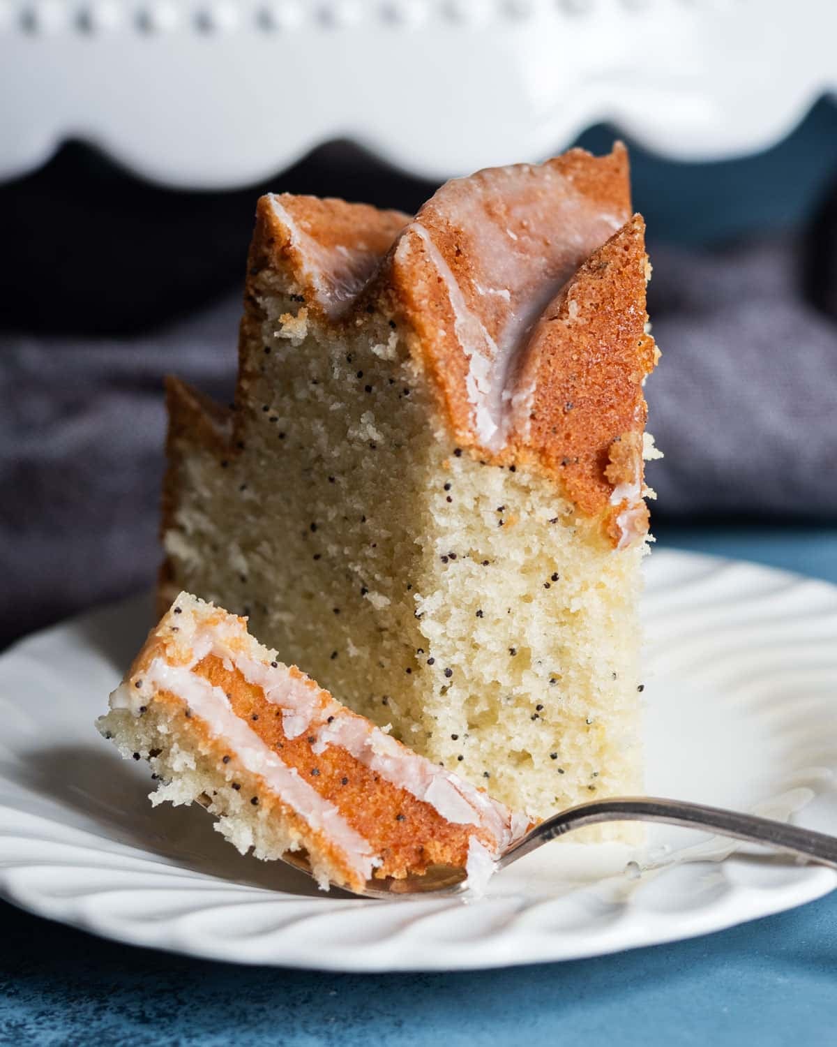 a piece of poppy seed bundt cake with a bite on a fork