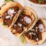 3 beef barbacoa tacos on a table