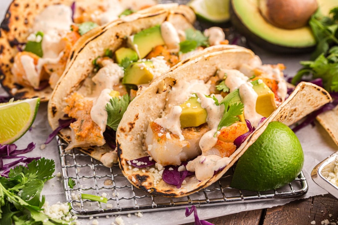 closeup of flaky fish tacos on a table