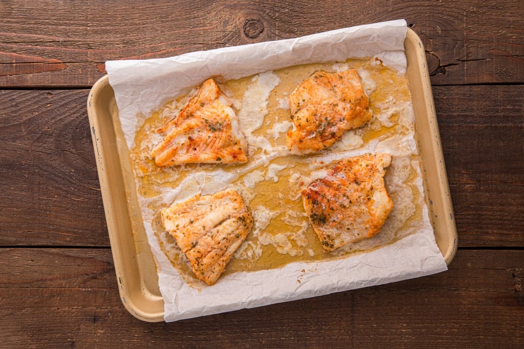 baked cod on a baking sheet