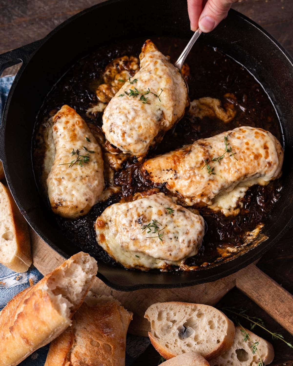a piece of french onion chicken on a spatula
