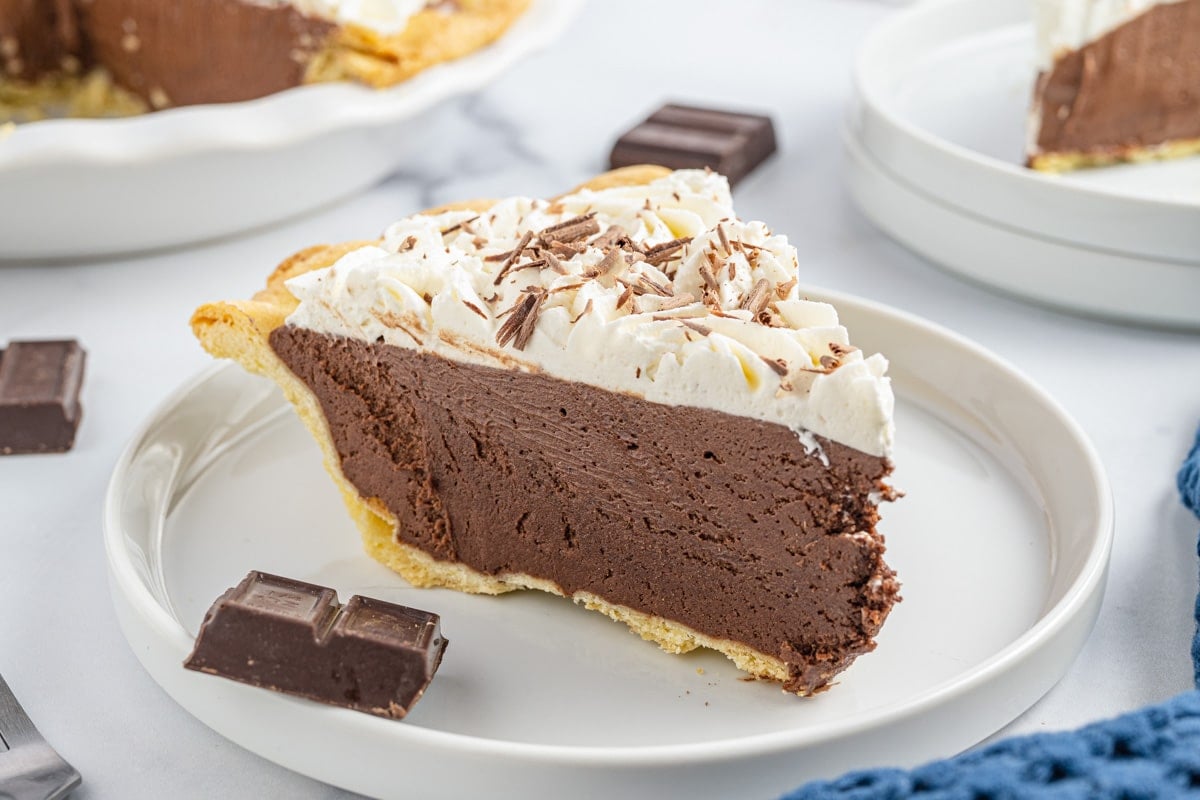 a slice of french silk pie with whipped cream on top
