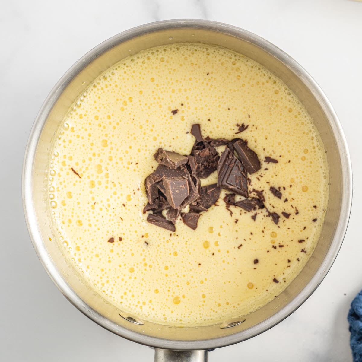 chocolate over egg mixture in a saucepan