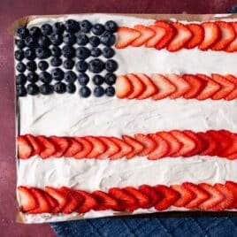 closeup of a flag sheet cake with strawberries and blueberries