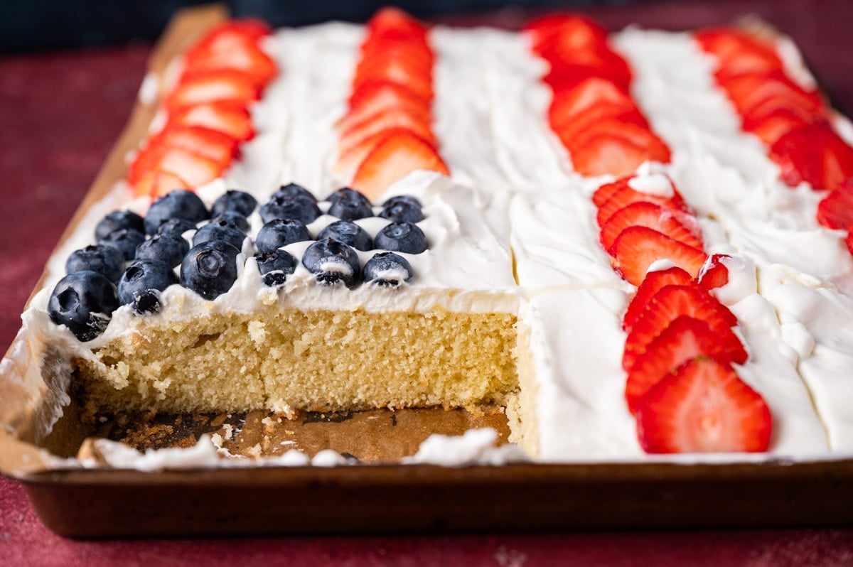 a patritoitic sheet cake in a pan with one slice out