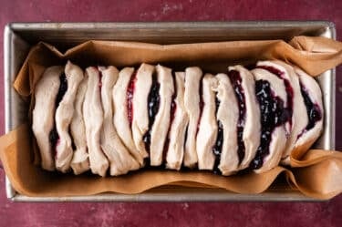 unbaked pull apart bread with jam in a pan