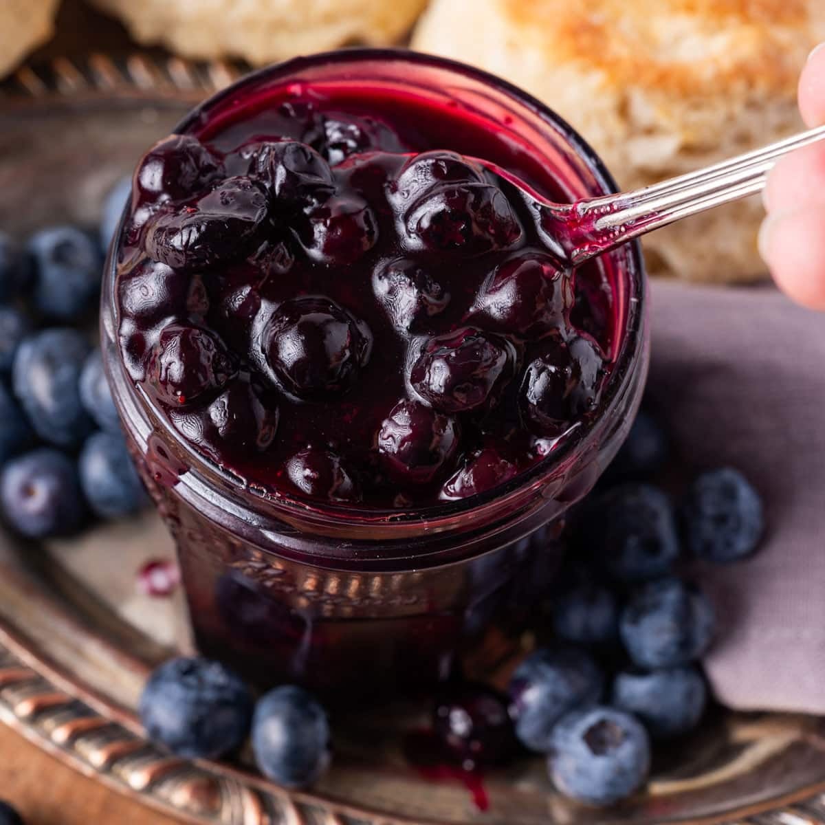 blueberry compote in a jar with a spoon