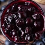 a spoonful of blueberry sauce in a jar