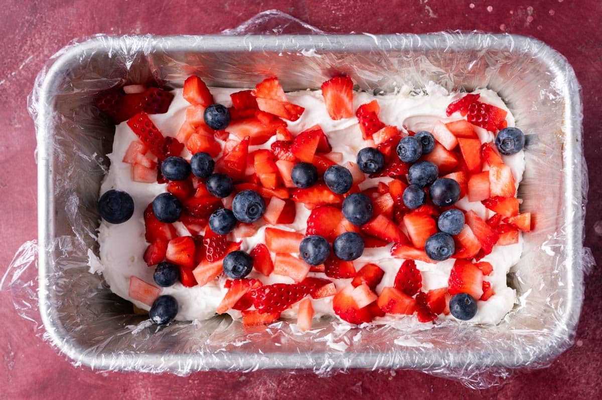 fresh fruit over whipped cream in a pan