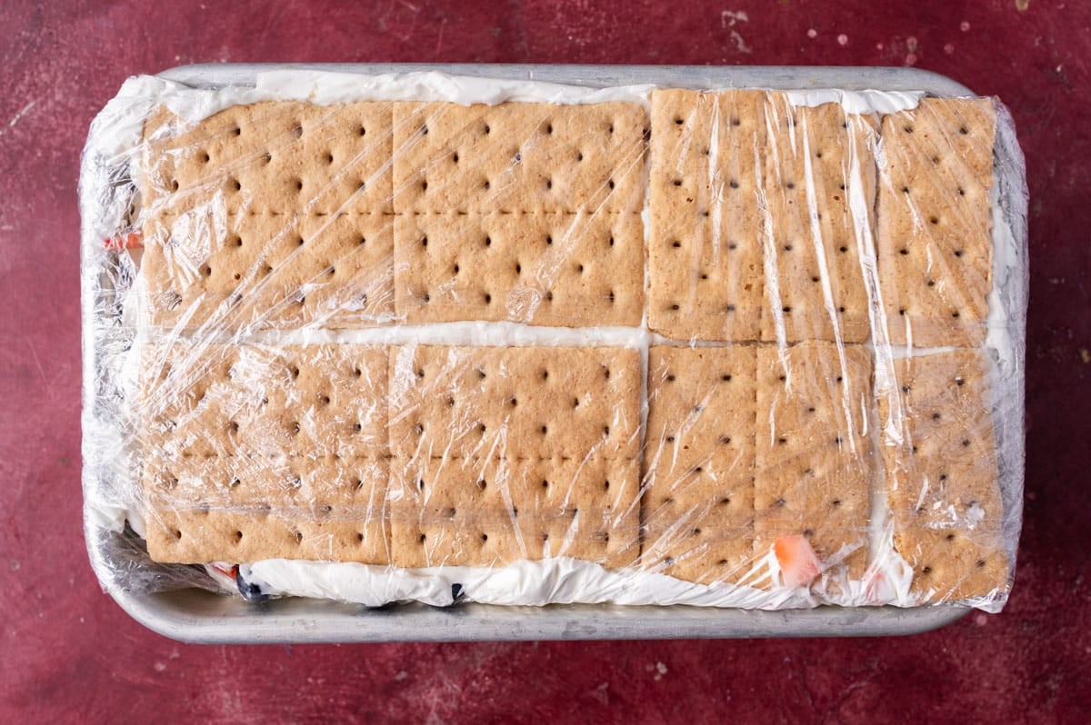 icebox cake with graham crackers wrapped in a pan