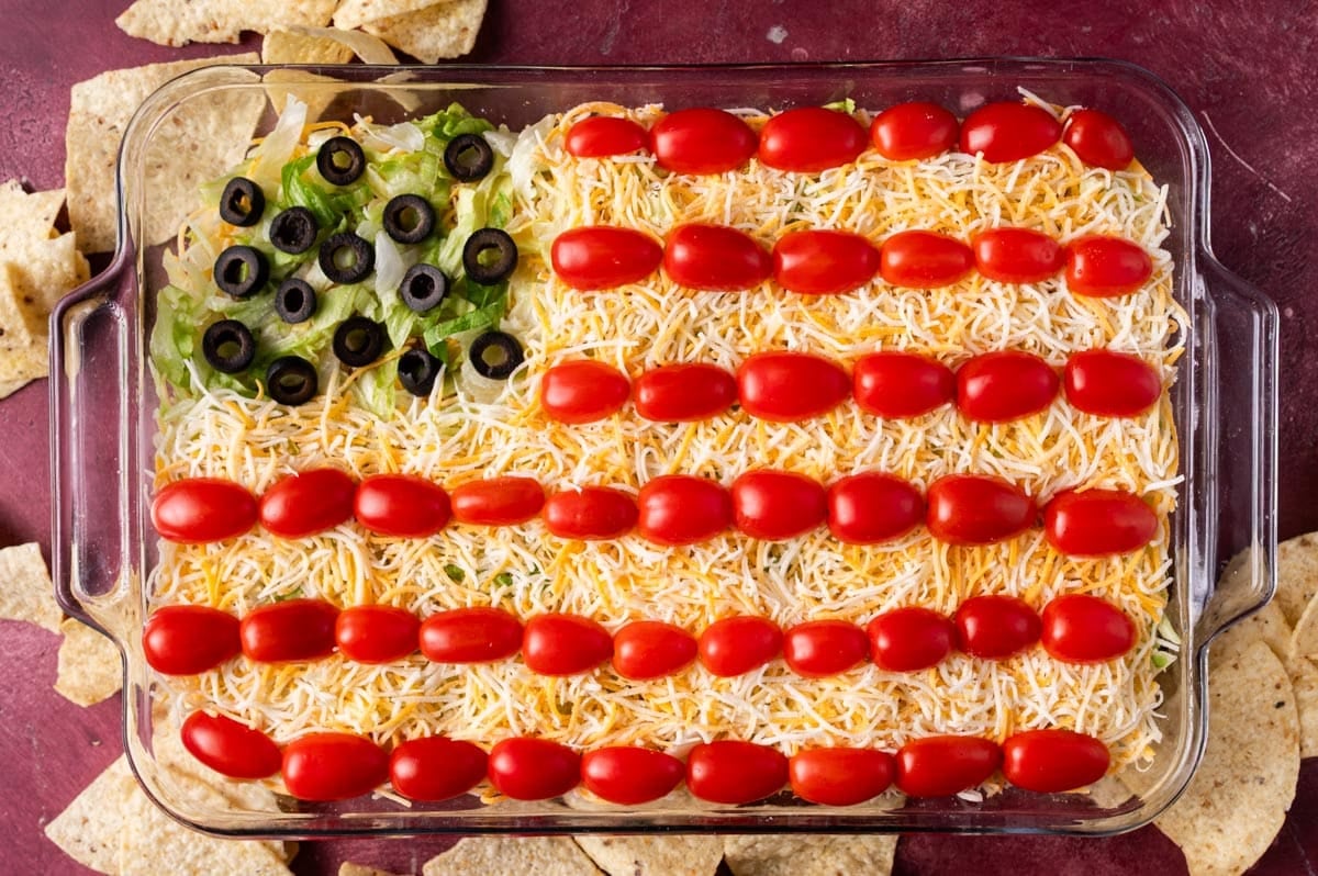 american flag taco dip on a table with tortilla chips