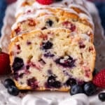 a loaf of mixed berry bread with blueberries and strawberries