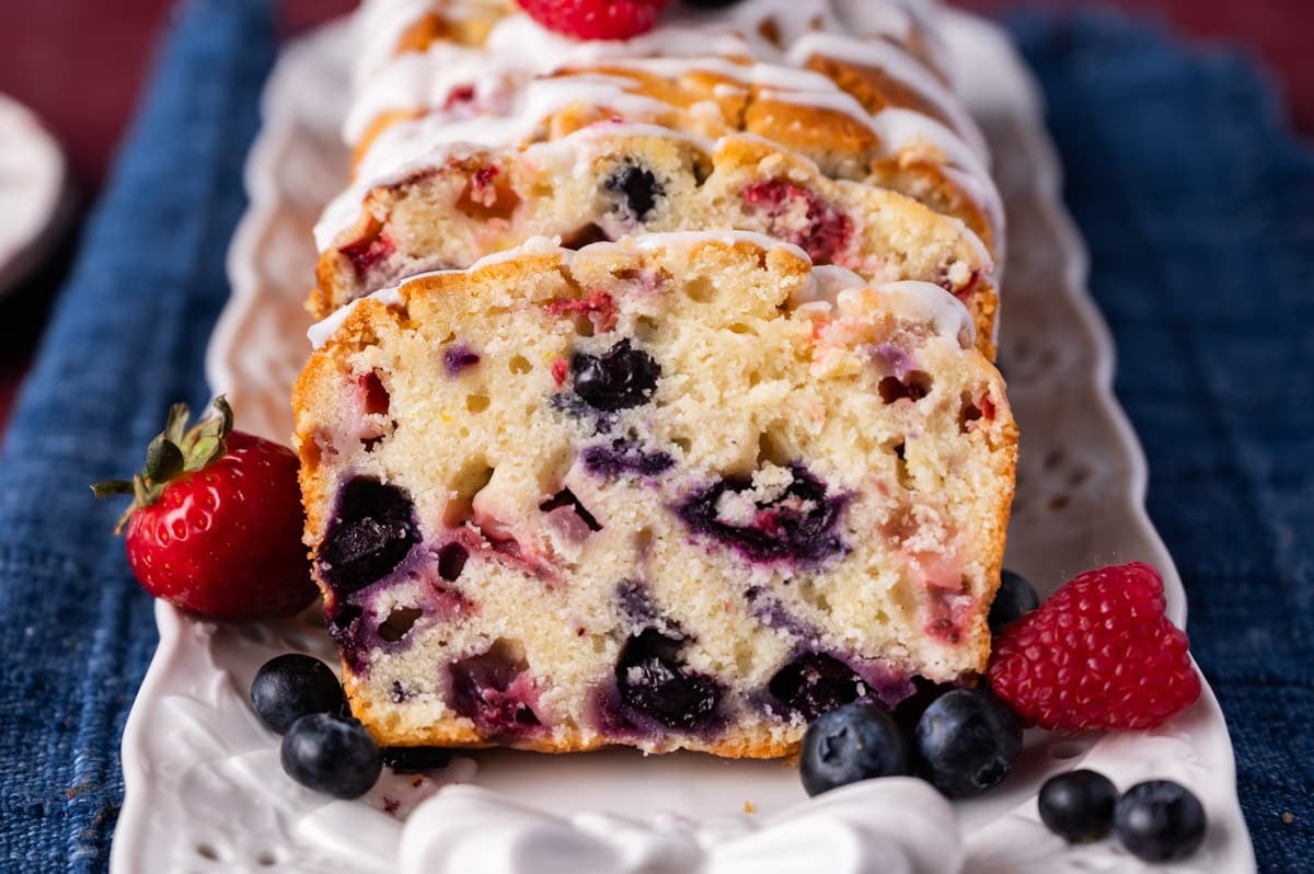 a loaf of mixed berry bread with blueberries and strawberries