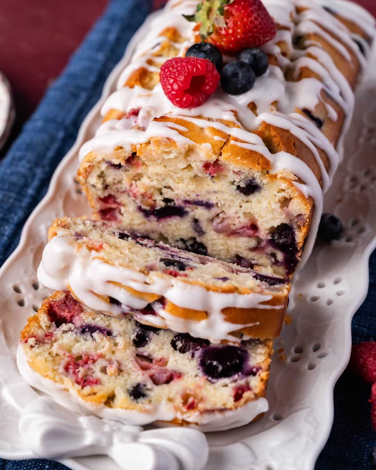 a loaf of quick bread with lemon glaze on a plate