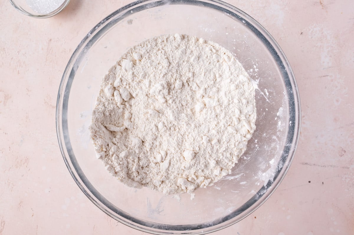 dry ingredients with butter pressed in in a glass bowl