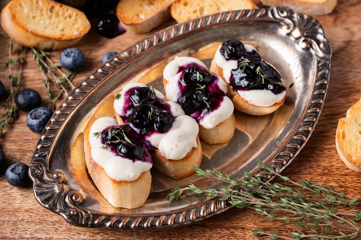 ricotta toast with blueberry thyme jam on a silver plate