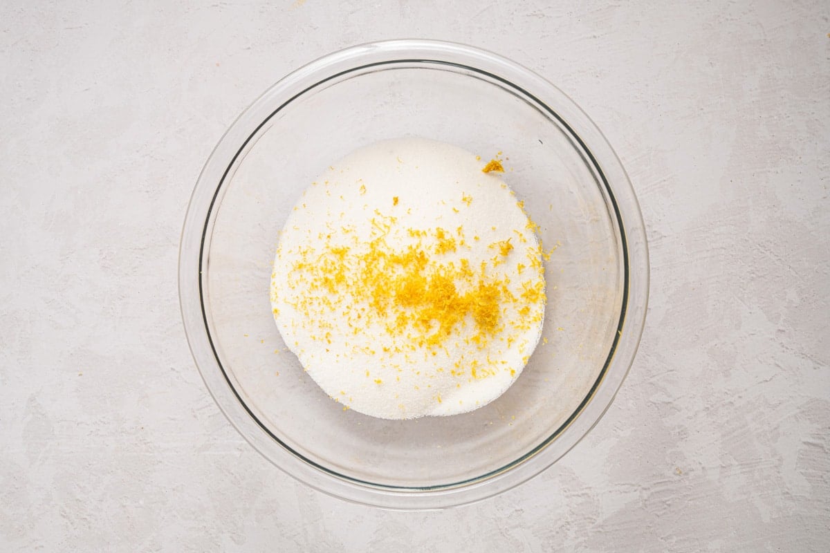 lemon zest over sugar in a bowl
