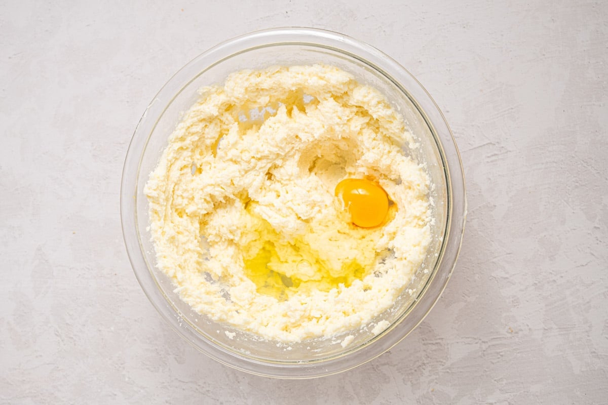 eggs over creamed butter and sugar in a bowl